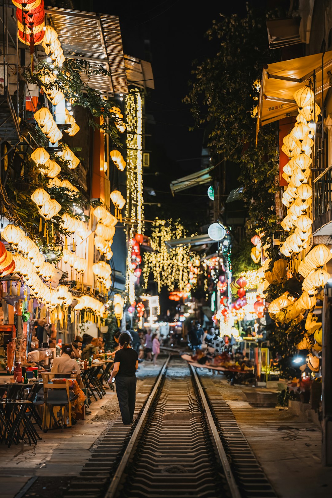 Photo by Benjamin Chambon A person walking down a street at night