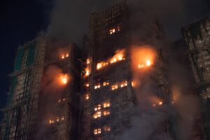 Skyscraper engulfed in flames at night